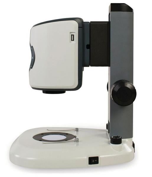 The image shows a medical device with a rectangular head and a round base. It has a lens at the front, a large button, and a USB port on the side. Ideal for eye examinations.