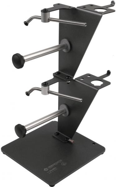 The image shows a sturdy, rectangular stand made of black metal. It features two vertical tubes that taper upwards, along with various mounts on the top.