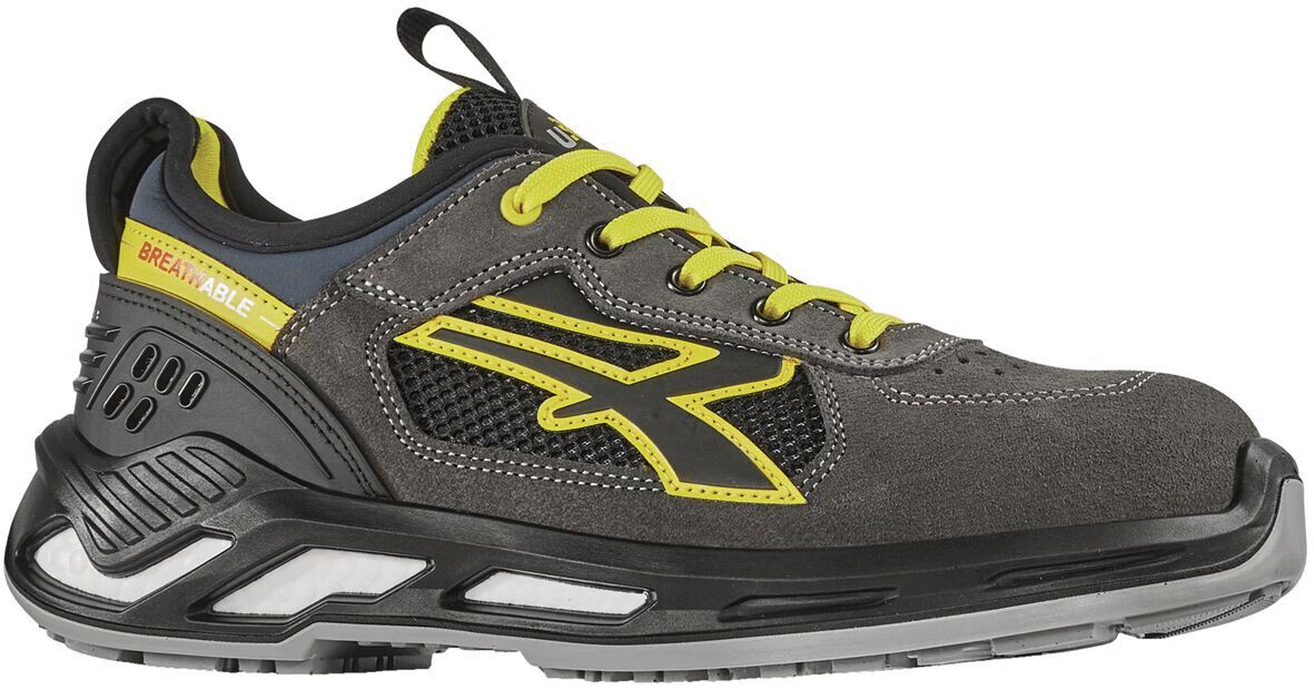 The shoe is a sporty gray half-shoe with black and yellow accents. It has a grippy sole and breathable mesh areas. The shoelaces are yellow.