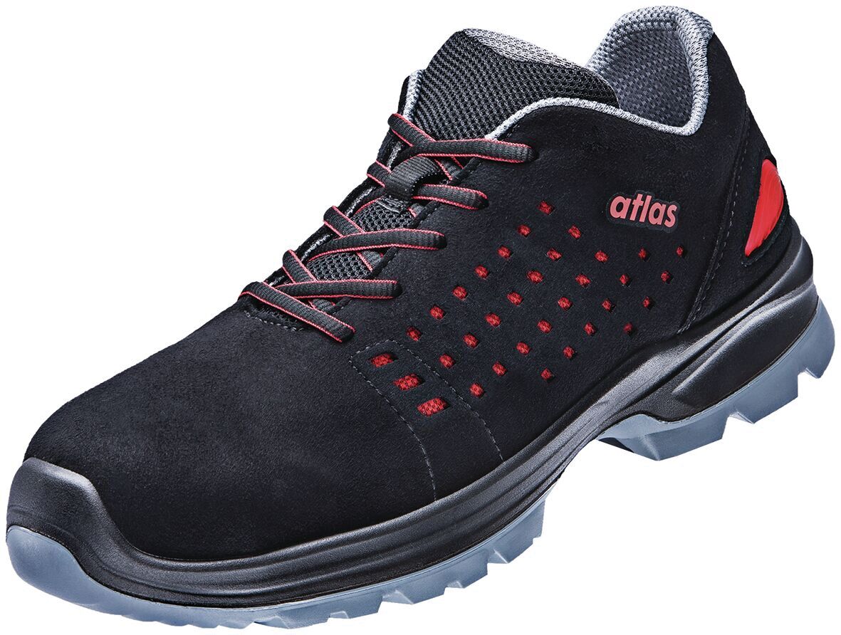 The shoe is made of black suede with red accents. It has a flat rubber sole and is slightly raised at the back. The shoelaces are red, and the lining is light.