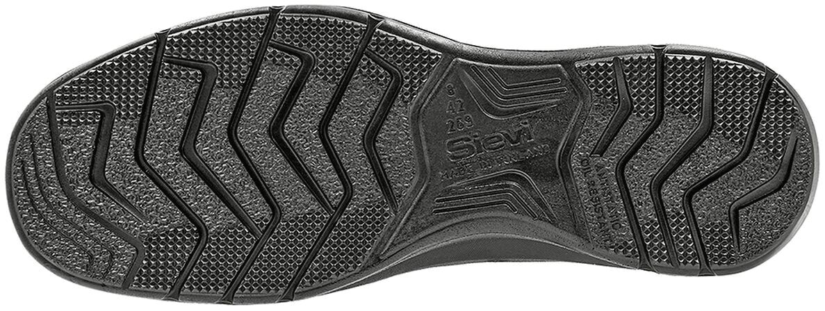 The image shows the underside of a shoe. The sole is dark black with various tread patterns that provide non-slip grip. There are both diagonal and vertical lines.