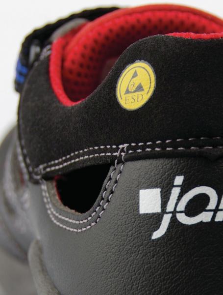 The image shows the heel of a shoe in black with red accents. A yellow emblem indicates the ESD function. The lettering "ja..." is visible on the side.