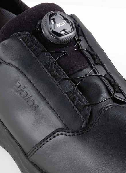 The image shows a black, modern shoe with a smooth surface. At the top, there is a flexible quick-lacing system with a convenient twist lock.