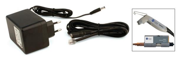 The image shows a black power supply unit with two electrical cables leading out. On the right side, there is a small illustration of a handheld device with a long handle and a connector.