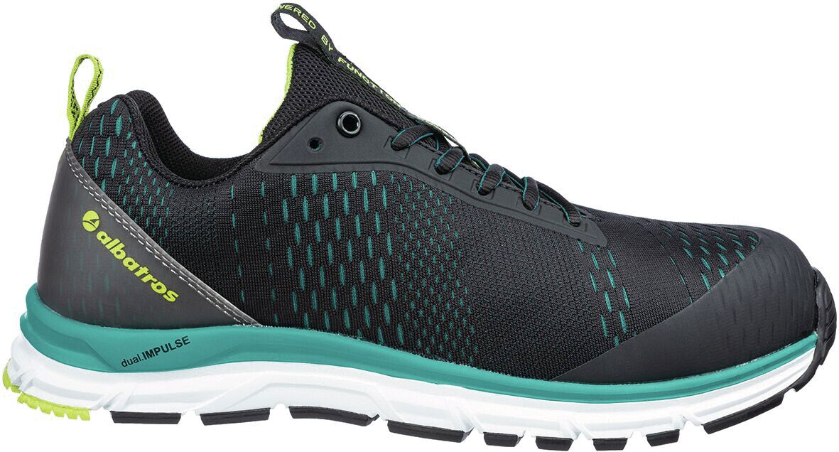 The shoe is sporty and modern, predominantly black with green accents. The surface is textured, and the sole is stable and flexible, ideal for outdoor activities.