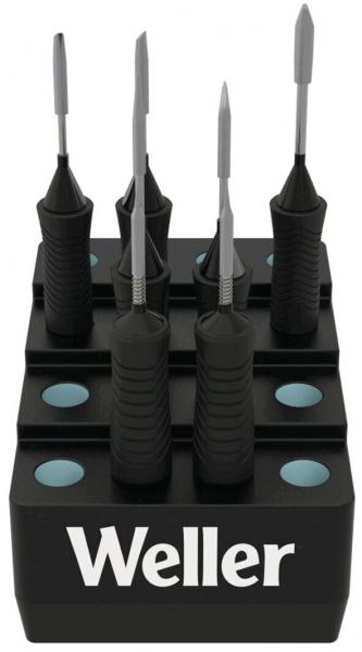 The image shows a black stand with several screwdrivers. The handles are roughly finished, and the stand has the inscription "Weller". It has four recesses for holding the tools.