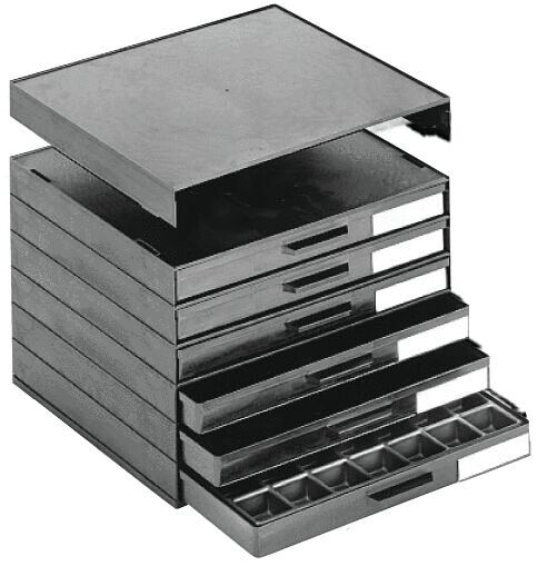 The image shows a black drawer unit with several compartments. There is a flat top surface, with five drawers underneath, some of which are partially pulled out.