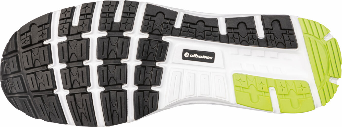 The image shows the sole of a sports shoe. The sole has a black rubber top with a non-slip tread and is white on the sides with green accents.