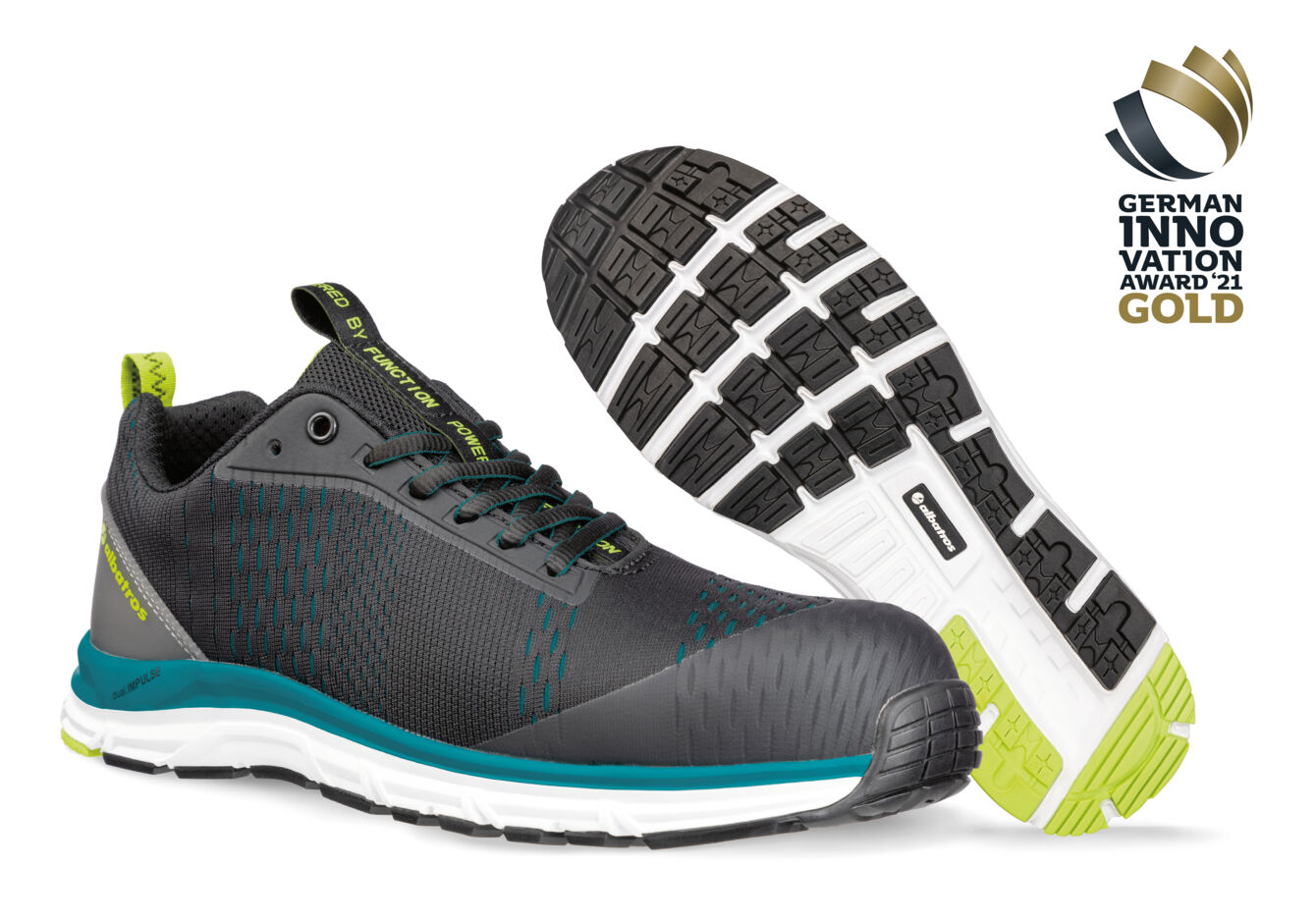 The image shows a pair of athletic shoes in black with green and blue accents. The sole has a non-slip tread. A gold award for innovation is depicted in the corner.