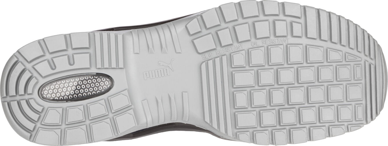 The image shows the sole of a shoe. It is white with a coarse, non-slip tread consisting of various horizontal and vertical grooves and patches.