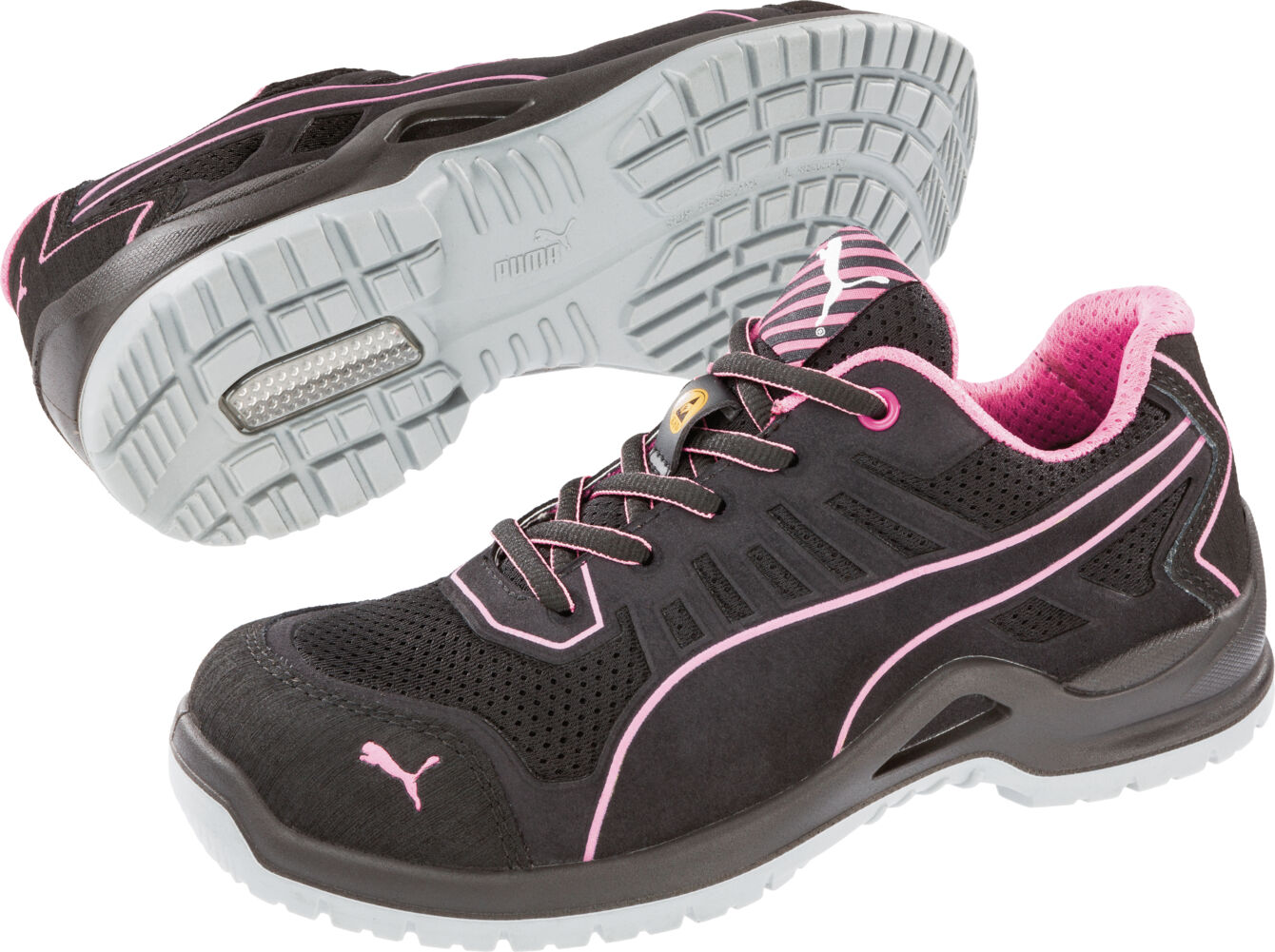 The image shows black sports shoes with pink accents. They feature a padded insole, laces, and a textured gray rubber sole for good traction.