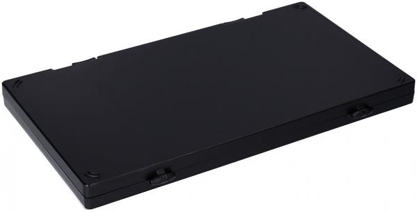 The image shows a flat, rectangular, black box. It has slightly rounded corners and features a smooth surface. There are small indentations in the center.