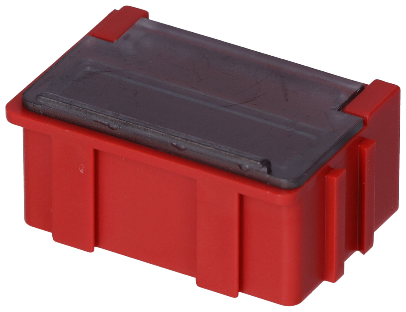 The image shows a small, rectangular box in bright red with a transparent lid. It has raised areas on the sides that facilitate gripping.