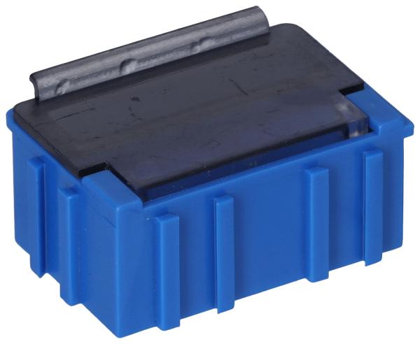 The image shows a small, rectangular box in bright blue with a smooth, black lid on top. The box has vertical grooves on the sides and a metallic bracket on the lid.