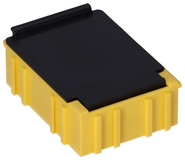 The image shows a small, rectangular box. It has a yellow base with vertical ridges and a black lid. The box is flat and compact.