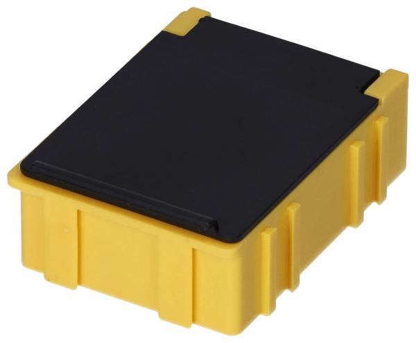 The image shows a rectangular box. The bottom is bright yellow with small grooves on the sides, the top is black and flat. The edges are slightly rounded.