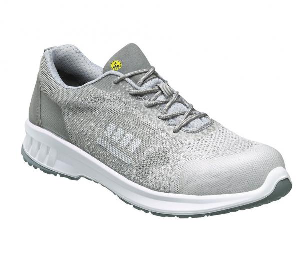 The shoe is sporty, light gray with a textured upper. It has a white, lightly padded sole and gray laces. The shape is slim and modern.