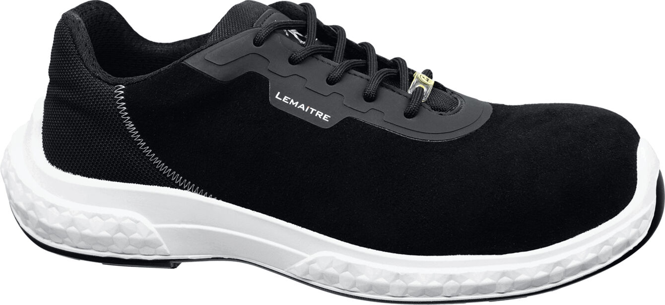 The shoe is black with a smooth surface and a white, textured sole part. It has laces and a sporty design, ideal for work or leisure.