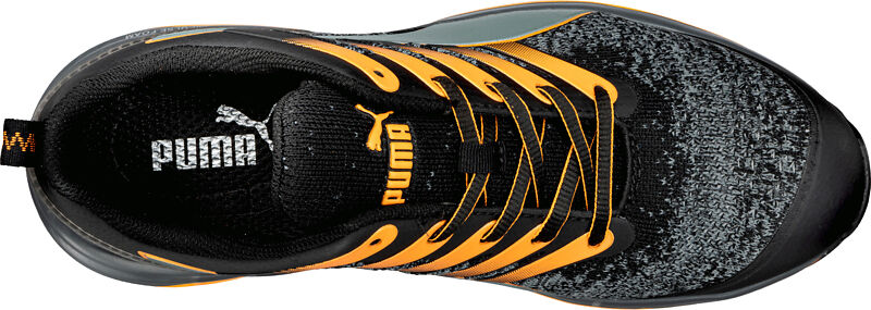 The image shows a sports shoe from above. It has a patterned upper in black and gray, with orange accents and laces. A Puma logo is visible on the tongue.