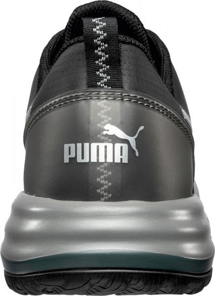 The shoe is black with gray and silver accents. The Puma logo is clearly visible on the heel. The sole is thick and has a textured profile.