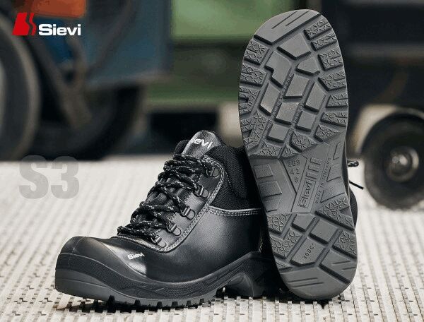 The image shows a pair of black work boots with high tops and lacing. Their sole has a coarse tread for better grip. The brand "Sievi" is visible.