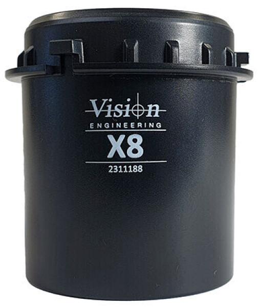 The image shows a black, cylindrical container with a closure on top. It features the inscription "Vision Engineering X8" and a number. The container has a sturdy, technical appearance.