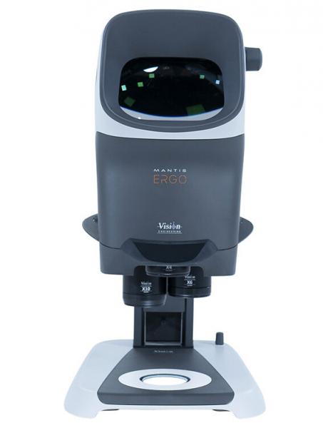 The image displays a modern visual aid device in an oval shape. It features a large, dark lens on top and a sturdy base. The device is designed to be functional and ergonomic.