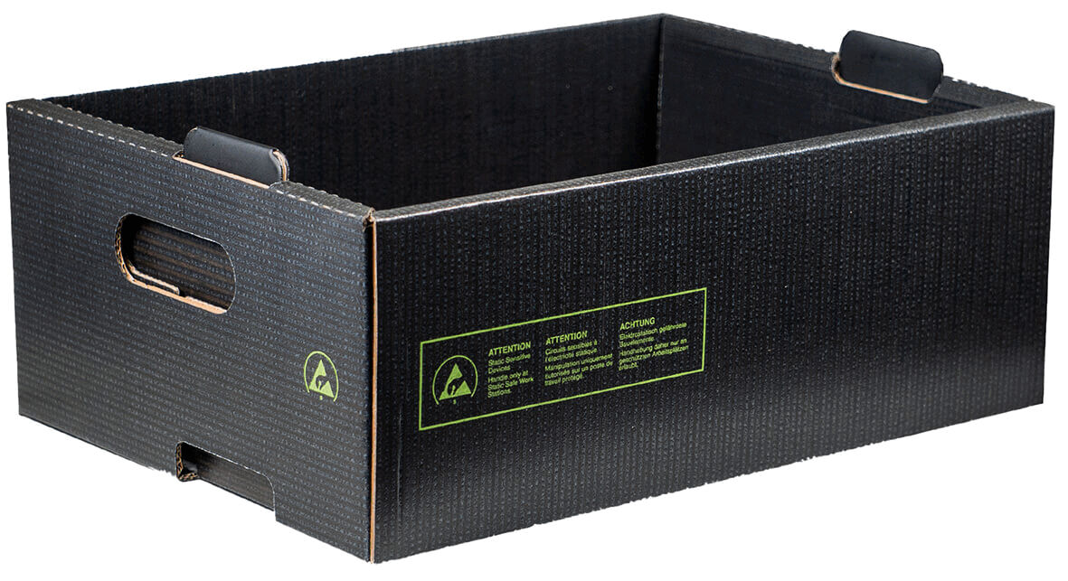 The image shows a rectangular, black cardboard box with handles on the shorter sides. The surface has a ribbed pattern, and there are green inscriptions on the side.