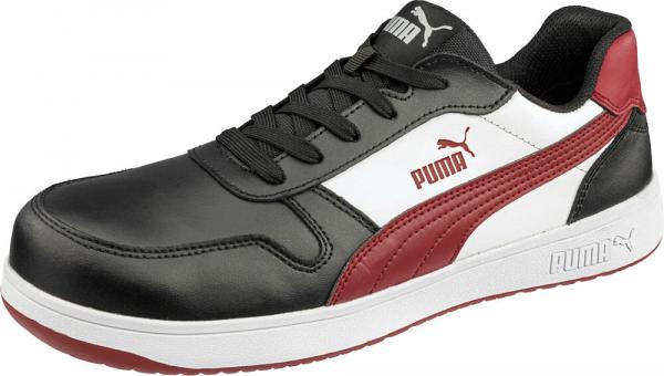 The shoe is sporty, predominantly black with white and red accents. It has a flat sole, laces, and the Puma logo on the side. Comfortable and modern in design.