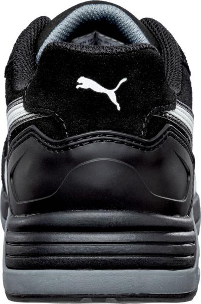 The image shows the back of a black sports shoe with gray and white accents. The sole is sturdy, and the upper is made from a combination of leather and textile.