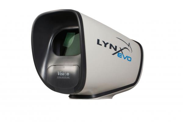 The image displays a device called LYNX Evo. It has an oval shape with a large, black viewport and a gray surface. The design is modern and functional.