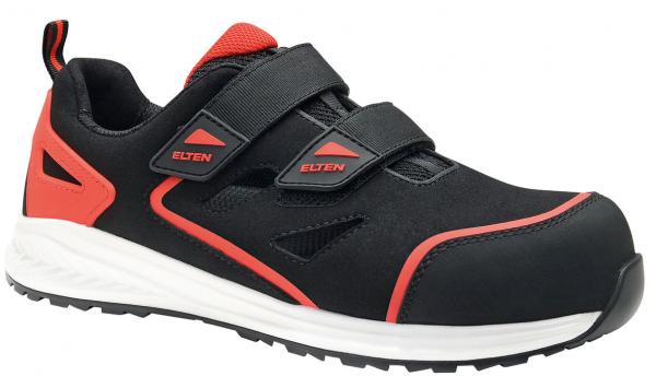 The shoe is black with red accents. It has two wide Velcro straps and a reinforced toe cap. The sole is light and has a coarse tread for better grip.