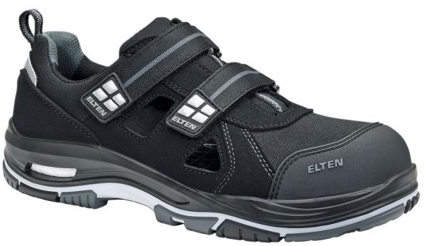 The shoe is a black work shoe with a sporty design. It has two wide Velcro straps and is made of durable material with a sturdy sole.