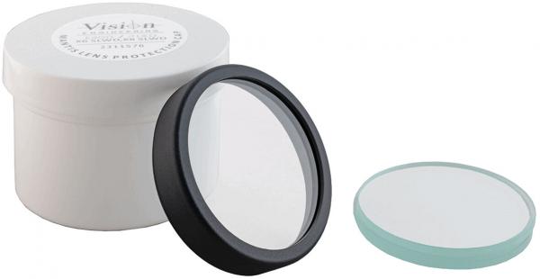 The image shows a round, white container with an inscription. Inside, there is a transparent lens with a black frame and another flat lens in mint green.