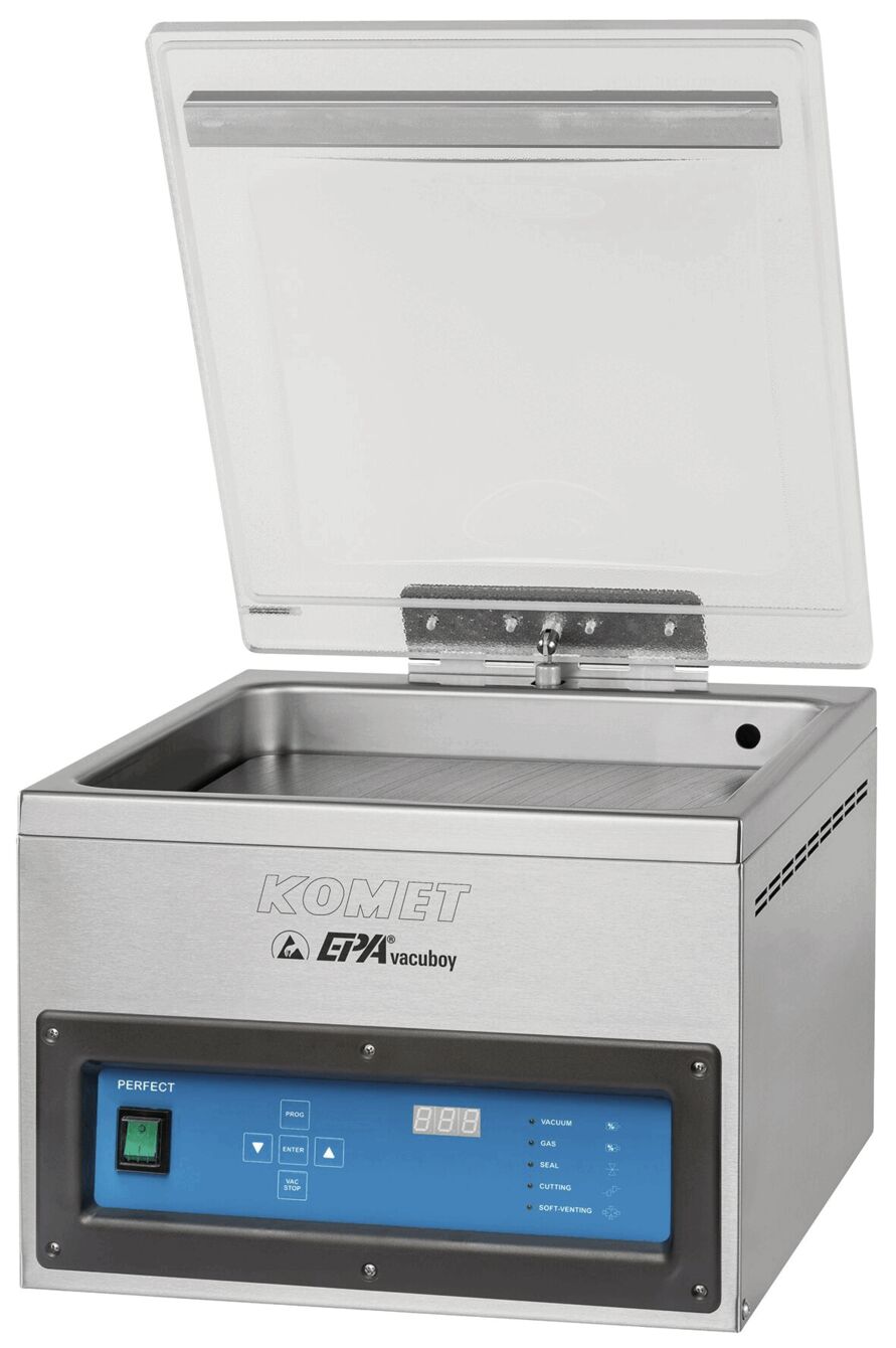 The image shows a kitchen appliance, a vacuum sealer. It has a rectangular, metallic casing with a transparent lid. On the front, there are controls and a digital display.