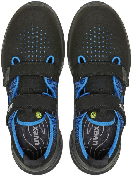 The image shows a pair of black shoes with blue accents. They have a sporty design, with two wide Velcro straps and a perforated surface for ventilation.