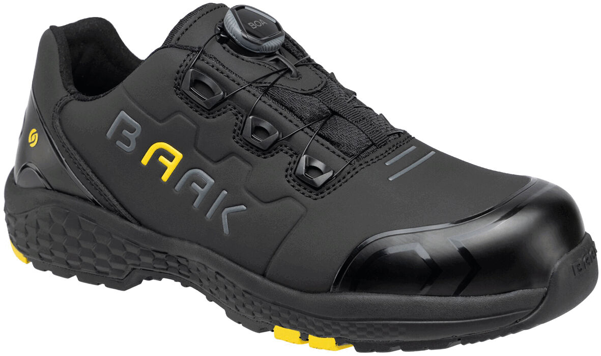 The shoe is black with yellow accents. It has a reinforced toe, a closed lacing system, and a non-slip sole. The surface is smooth, and the design is sporty.