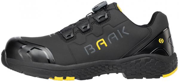 The shoe is blackish, with a sturdy rubber sole. It has a toe cap and yellow accents. The design is sporty and enclosed, with a quick lacing system.