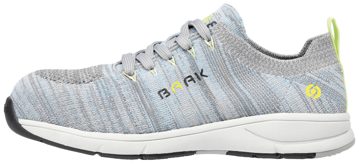 The shoe is a gray athletic shoe with a textured surface. It has a light sole, plain laces, and yellow accents on the heel and side. It appears light and modern.