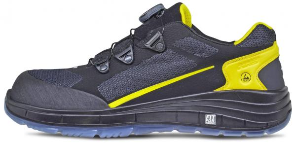 The shoe is a sporty, sturdy half-shoe in black with gray and yellow accents. It features a flexible sole and distinctive quick-lacing system that enhances comfort.