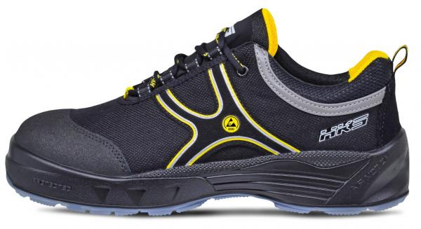 The image shows a black safety or work shoe with yellow accents. It features a comfortable, padded surface and a non-slip, sturdy sole. Laces are included.