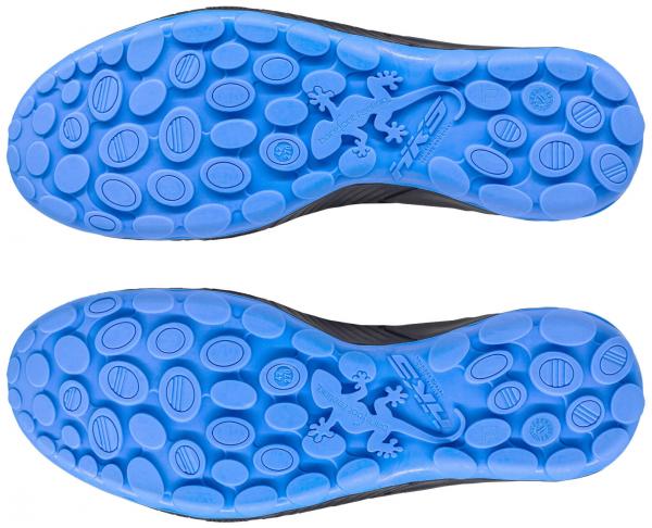 The image shows the sole of shoes with a blue rubber sole. The surface is equipped with various oval and round protrusions that provide good grip.