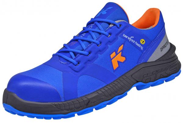 The shoe is sporty, primarily in bold blue with orange accents. It has a sturdy rubber sole and is designed with laces and a padded collar.