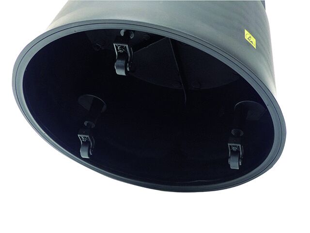 The image shows the inside of a cylindrical object in black. It has a smooth surface and four metal clips attached inside. A yellow label is visible.