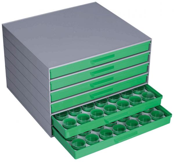 The image shows a flat, gray storage box with several green drawers. One drawer is pulled out and contains circular compartments for small objects.