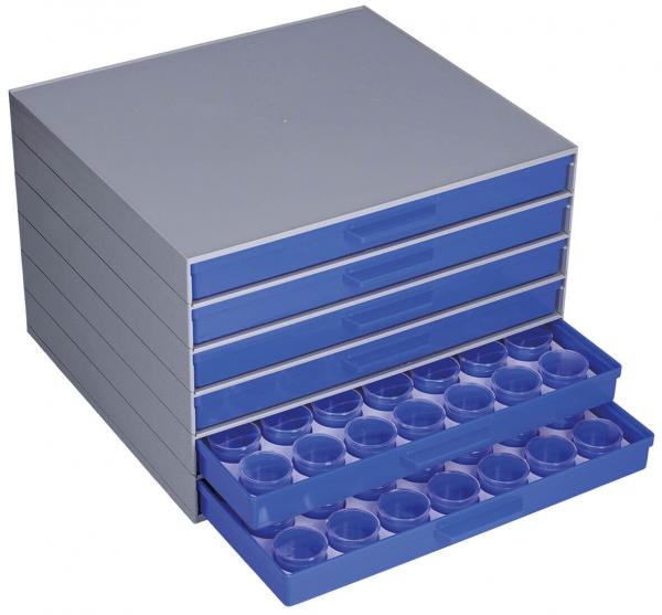 The image shows a flat, gray drawer box with several drawers. The bottom drawer is pulled out and contains 12 round depressions. The box is made of plastic, the drawers are blue.