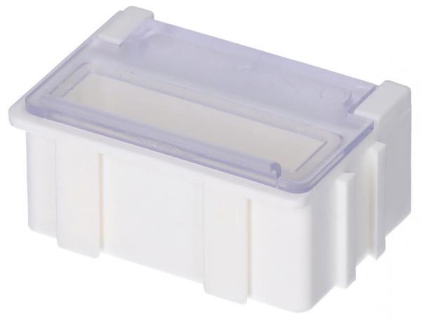 The image shows a rectangular, white plastic box with a transparent lid flap. It has four small feet and is slightly elevated in the center. The flap is open upwards.