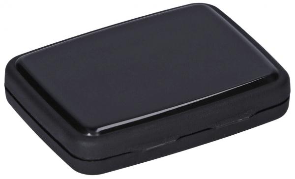 The image shows a rectangular, flat object in matte black. It has rounded corners and a smooth surface. On the side, there may be small openings or indentations visible.