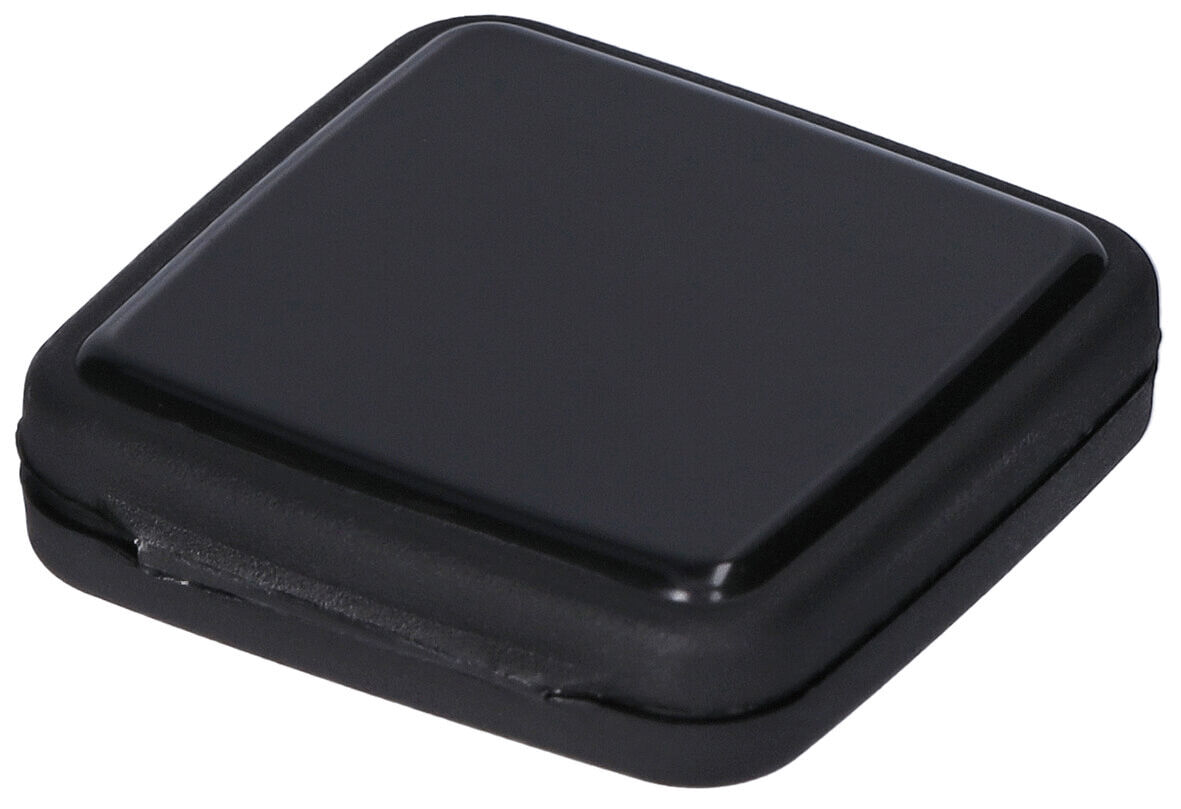 The image shows a square, flat object in shiny black. The edges are rounded, and it has a slightly raised center. It appears modern and minimalist.