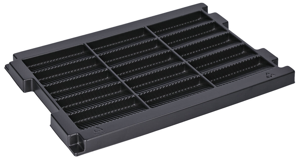 The image shows a flat, black plastic tray with recessed grooves. It features several uniform compartments and is rectangular, with beveled edges. Ideal for organizing items.